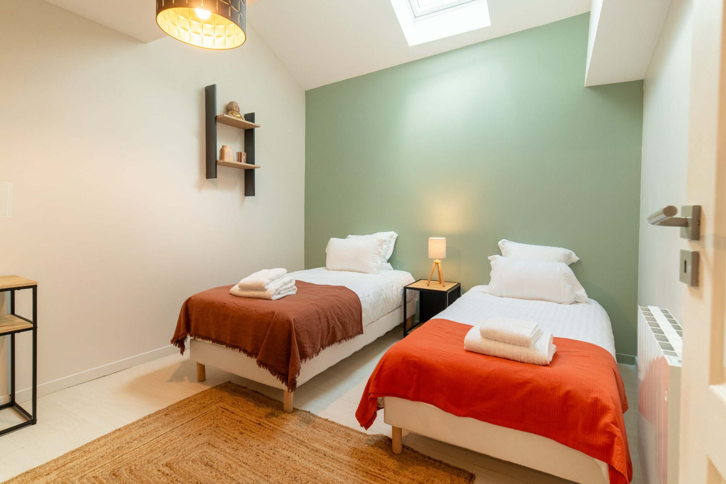 Chambre à deux lits simples aux tons vert amande